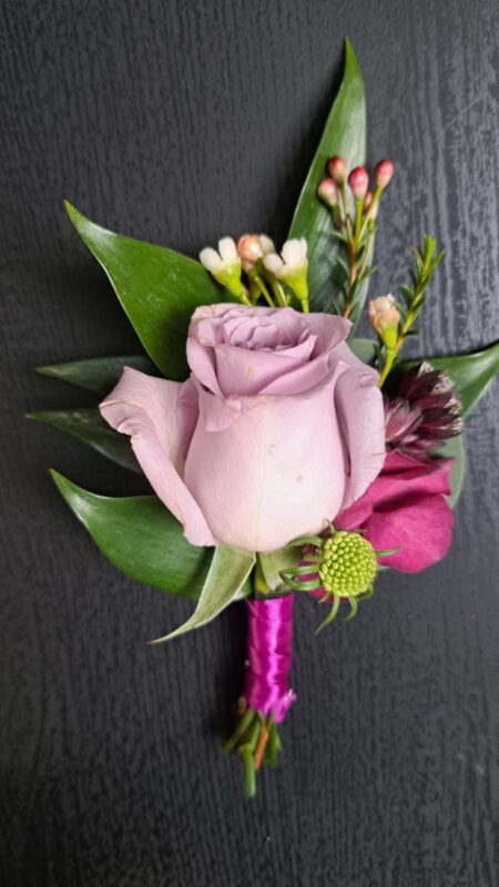 Lilac buttonhole with rose and ruscus