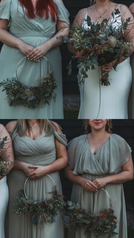 Bridesmaids in sage dresses holding green and white flower hoops