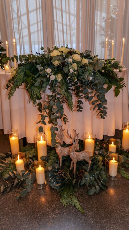 Christmas theme top table arrangement. White roses and eucalyptus