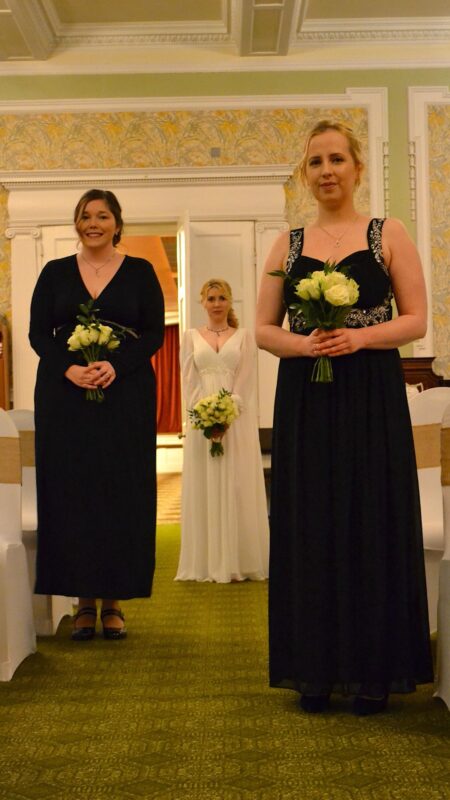 white and black theme wedding with white rose bouquets.