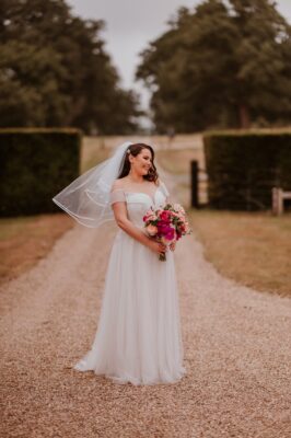 Bride looks stunning with her wedding bouquet of pinks