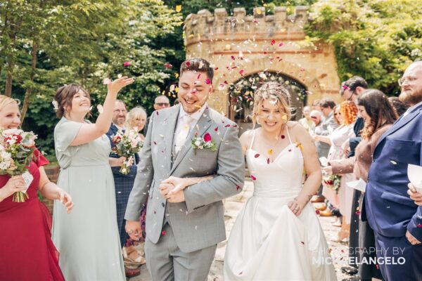Bride and Groom walk the confetti line at their wedding.