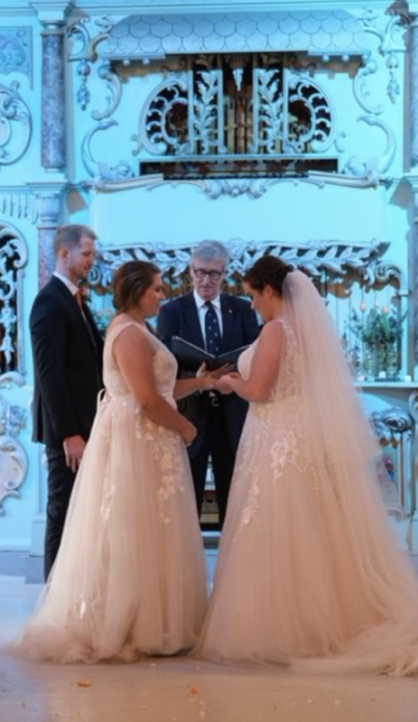 Paul from rainbow weddings marrying two brides.