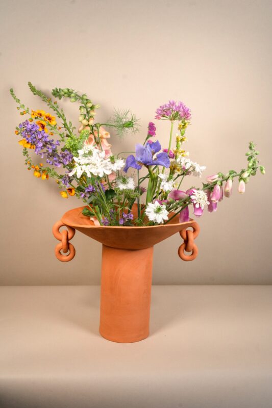 Mudfired Vase filled with blooming roza's flowers