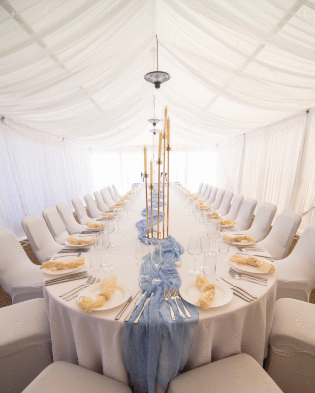 Beautiful Blue wedding set up. Table runners in blue, white flowers, minimalist chic.